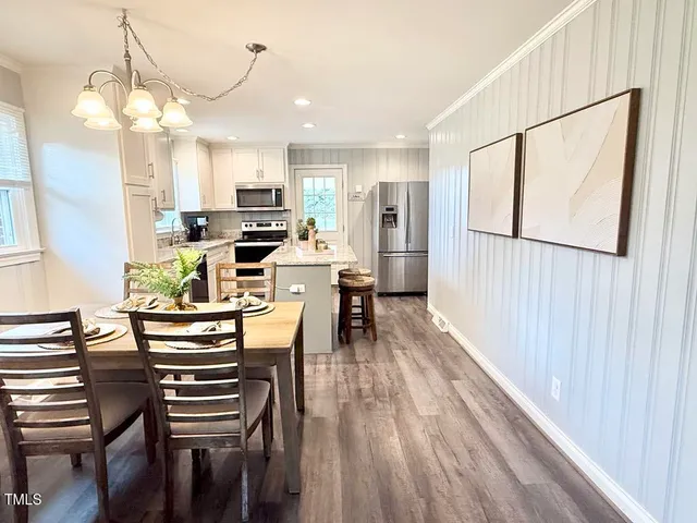 a view of a dining room with furniture and wooden floor