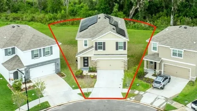 a aerial view of a house with a yard