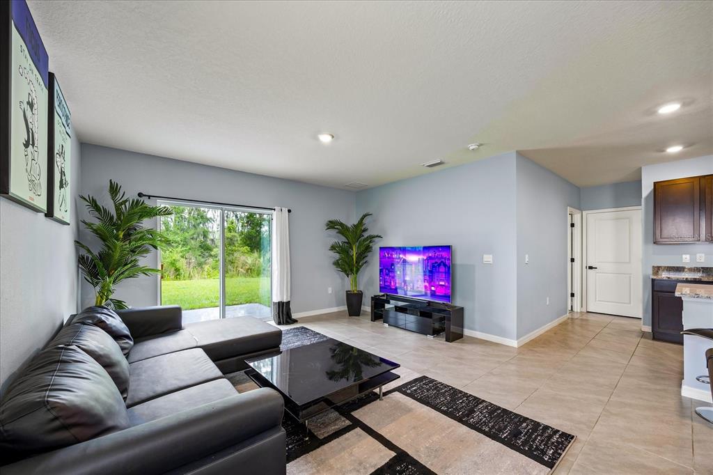 1680 Hazy Sea Drive Plant City, FL 33565 - Photo 11 of 49 a living room with furniture a flat screen tv and a large window
