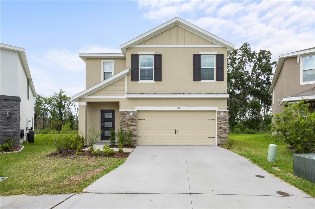 1680 Hazy Sea Drive Plant City, FL 33565 - Photo 2 of 49 a front view of house with a yard