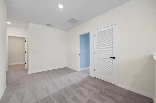 a bedroom with a bed and a night stand