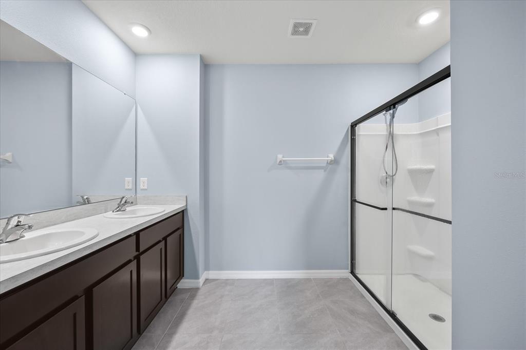 1680 Hazy Sea Drive Plant City, FL 33565 - Photo 29 of 49 a bathroom with a double vanity sink and mirror