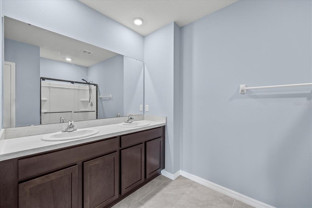 1680 Hazy Sea Drive Plant City, FL 33565 - Photo 30 of 49 a bathroom with a double vanity sink and a mirror