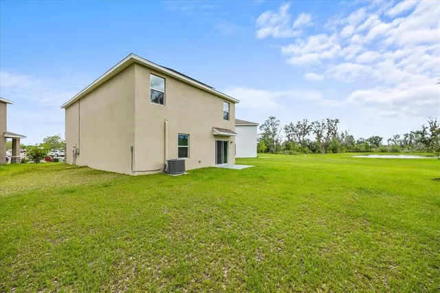 an aerial view of a house with yard swimming pool and outdoor seating