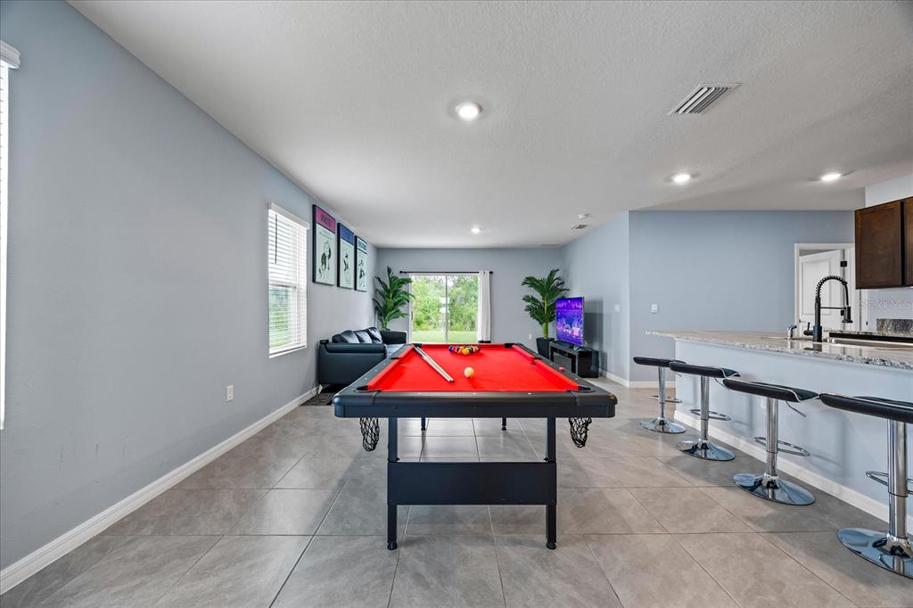 1680 Hazy Sea Drive Plant City, FL 33565 - Photo 7 of 49 a room with furniture a rug and a potted plant