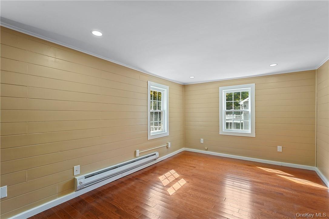 58 Whippoorwill Road East Armonk, NY 10504 - Photo 11 of 20 an empty room with wooden floor and windows