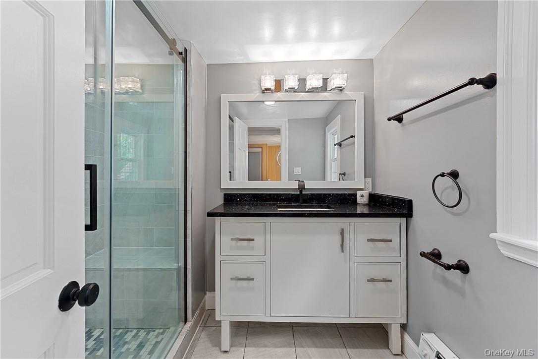 58 Whippoorwill Road East Armonk, NY 10504 - Photo 12 of 20 a bathroom with a granite countertop sink a mirror and shower