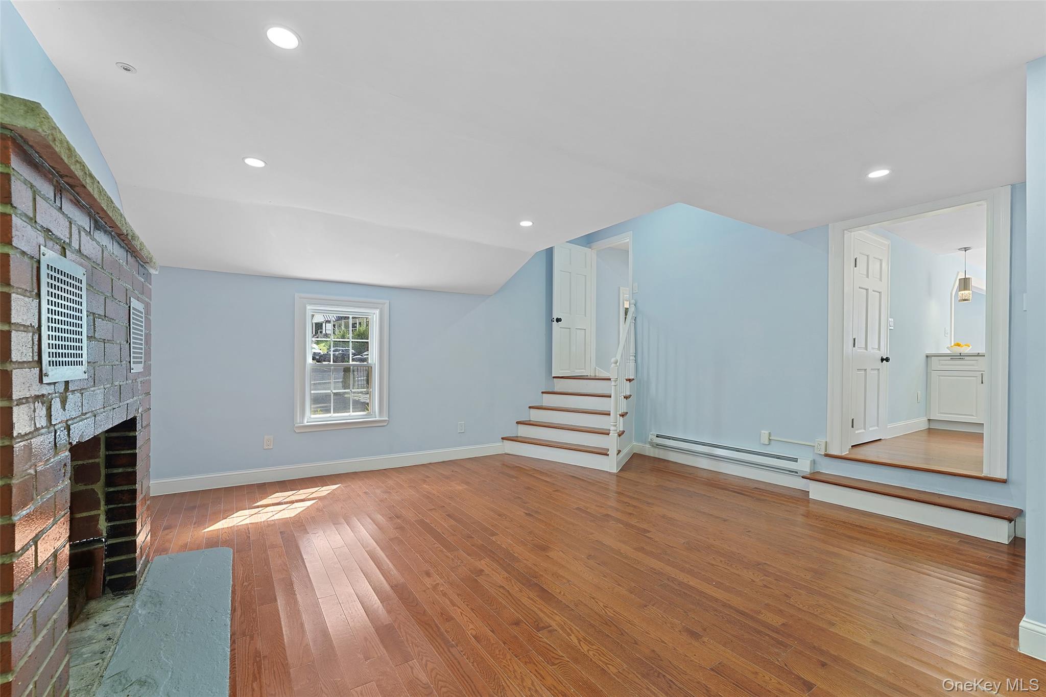 58 Whippoorwill Road East Armonk, NY 10504 - Photo 8 of 20 a view of empty room with wooden floor and fireplace