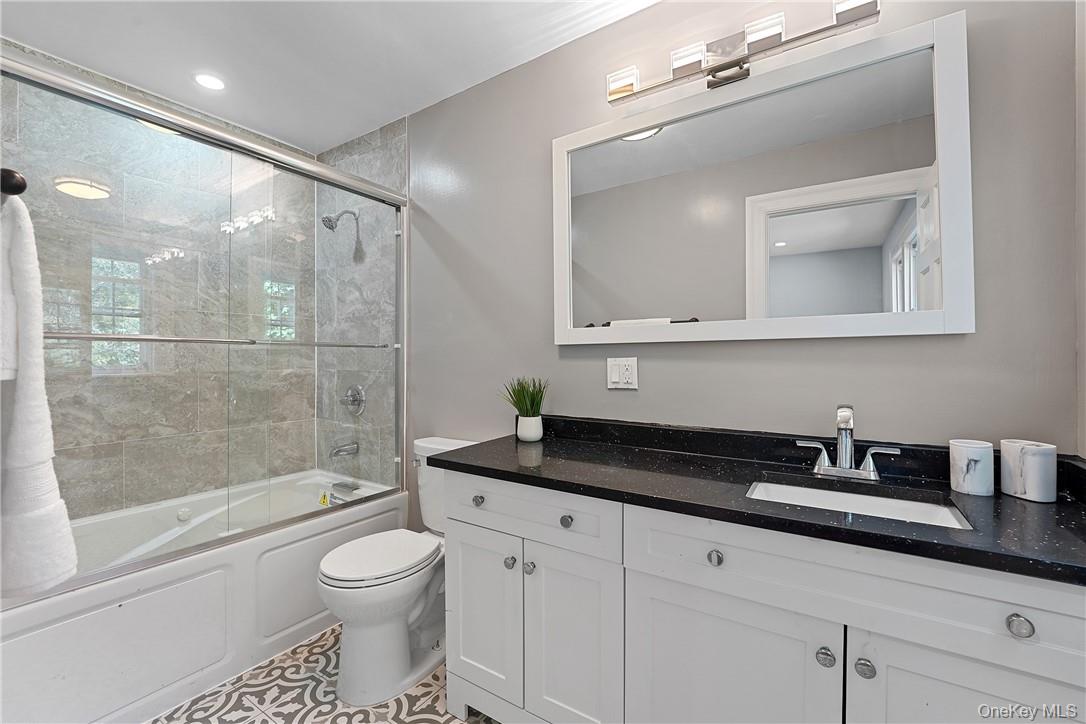 58 Whippoorwill Road East Armonk, NY 10504 - Photo 9 of 20 a bathroom with a granite countertop sink a toilet and shower