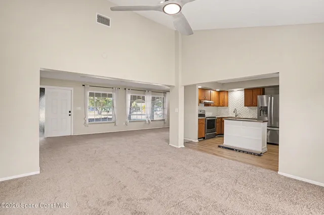 an empty room with furniture and windows