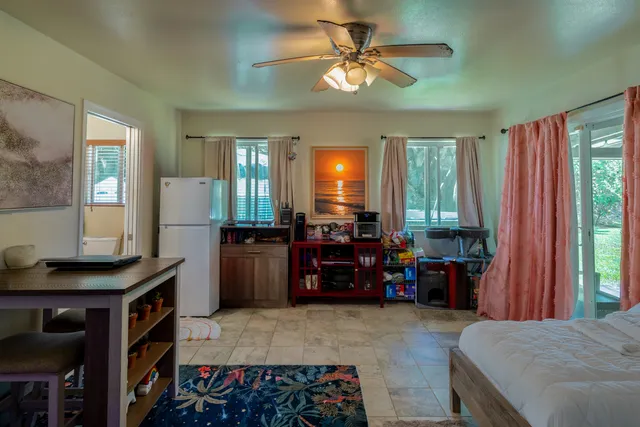 a large bedroom with a bed and a chandelier