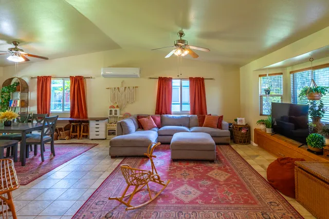 a living room with furniture and a chandelier