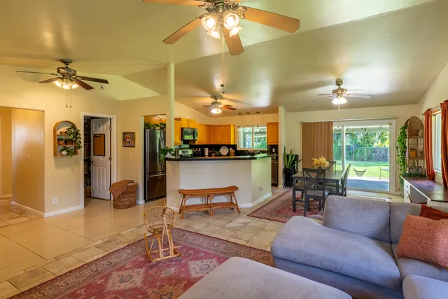 a living room with furniture a chandelier and a flat screen tv