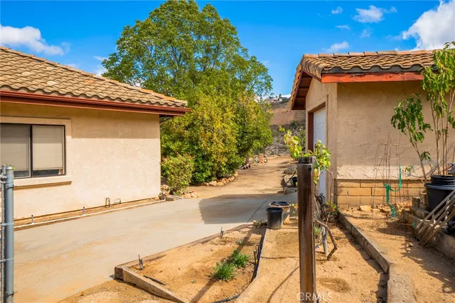a view of a patio with table and chairs and potted plants