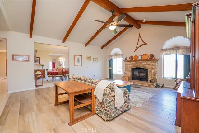 a living room with furniture a fireplace and a table