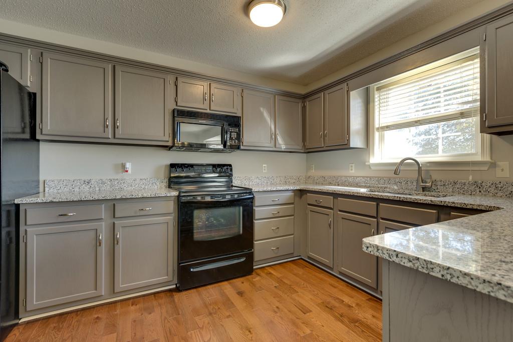 2105 Zion Road Columbia, TN 38401 - Photo 11 of 29 Kitchen has stunning granite countertops and beautiful gray cabinets.