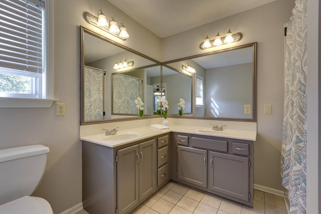 2105 Zion Road Columbia, TN 38401 - Photo 16 of 29 Double vanities, beautiful gray cabinetry, and large linen closet