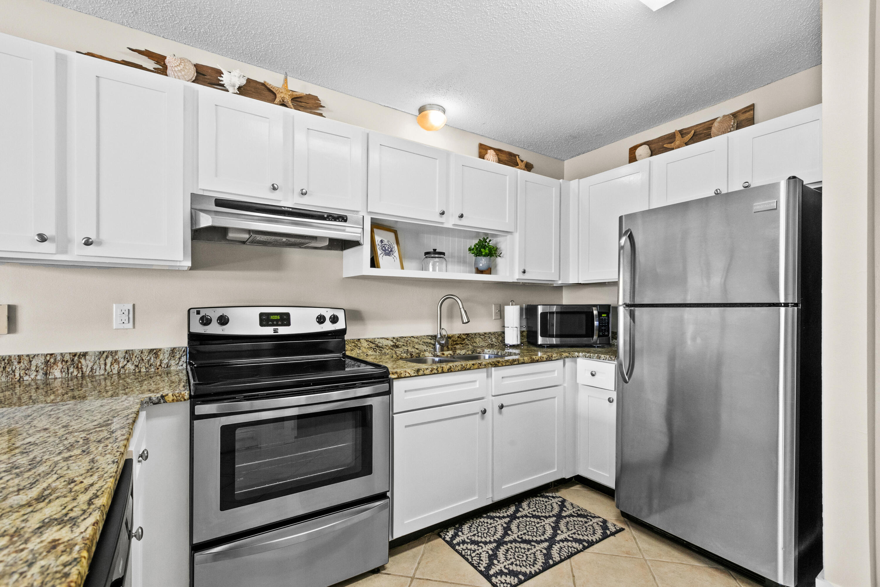 3799 East County Highway 30A, Unit F2 Santa Rosa Beach, FL 32459 - Photo 12 of 21 a kitchen with a white cabinets and white appliances