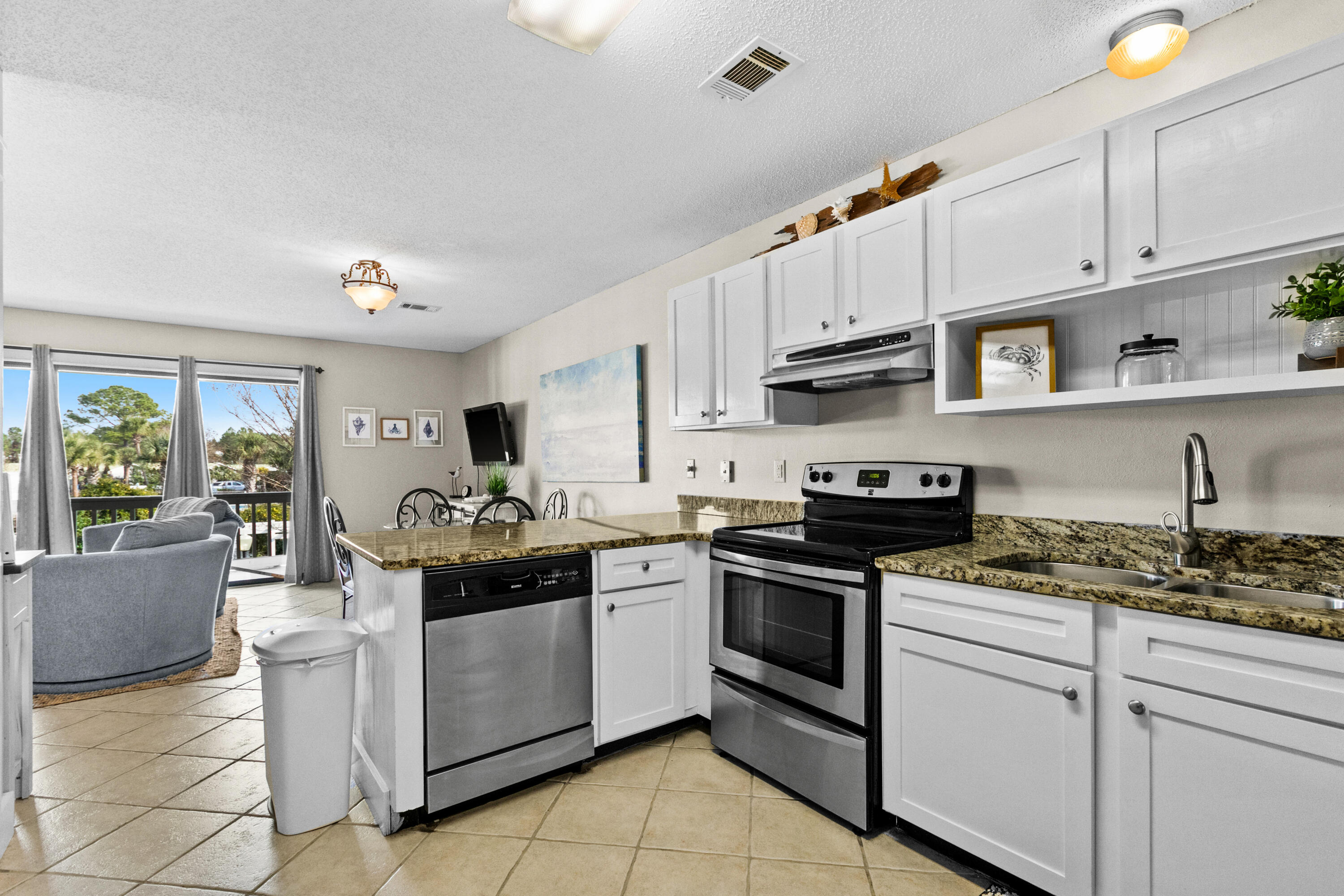 3799 East County Highway 30A, Unit F2 Santa Rosa Beach, FL 32459 - Photo 13 of 21 a kitchen with stainless steel appliances granite countertop a stove sink and cabinets