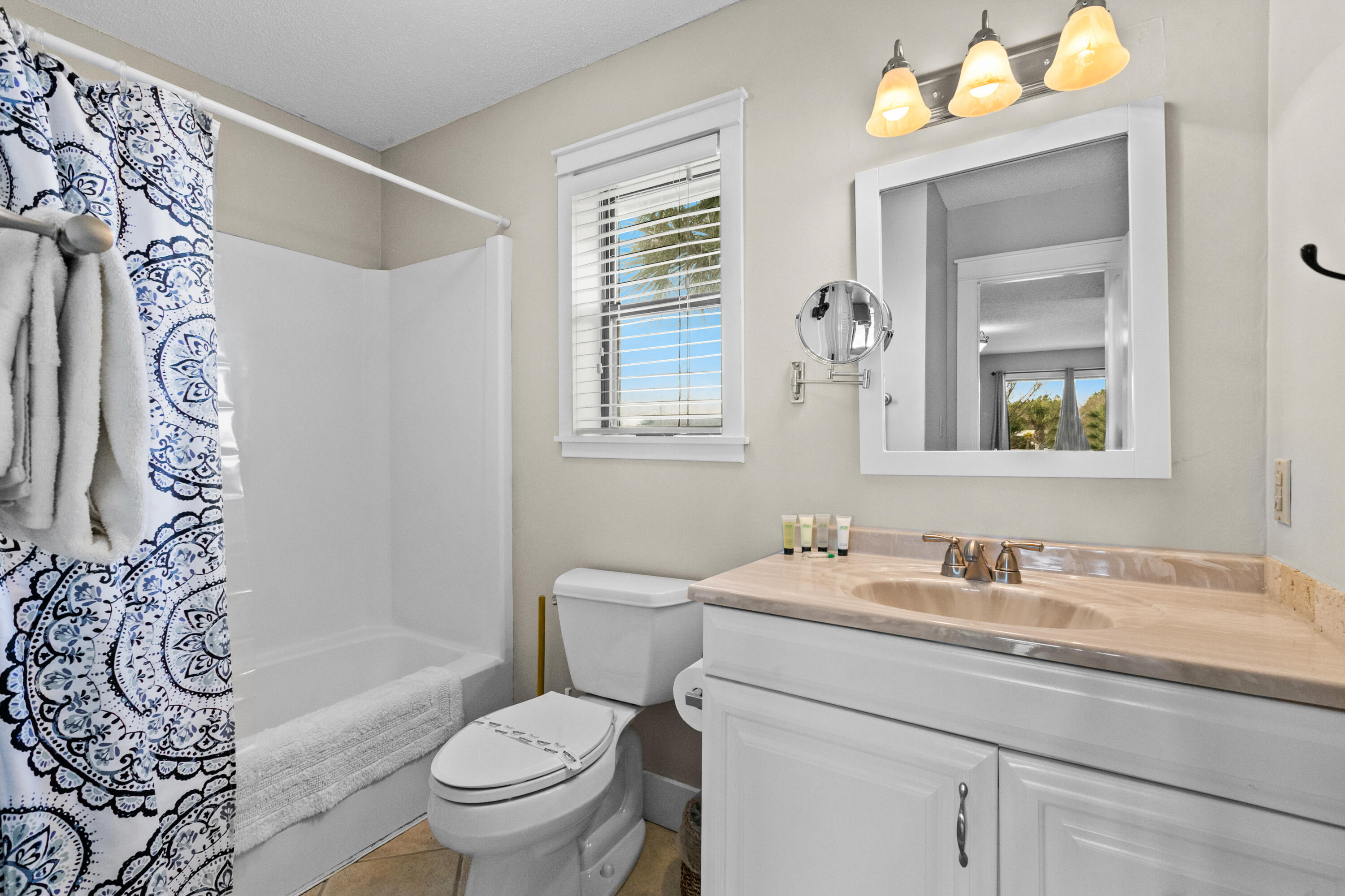 3799 East County Highway 30A, Unit F2 Santa Rosa Beach, FL 32459 - Photo 16 of 21 a bathroom with a granite countertop toilet a sink and a mirror