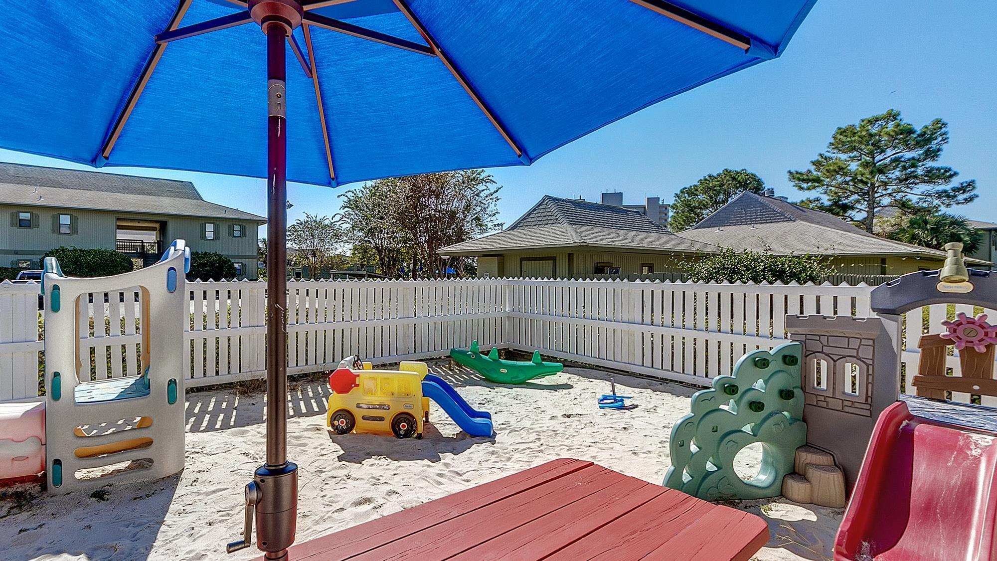 3799 East County Highway 30A, Unit F2 Santa Rosa Beach, FL 32459 - Photo 19 of 21 a view of a deck with furniture and table under an umbrella