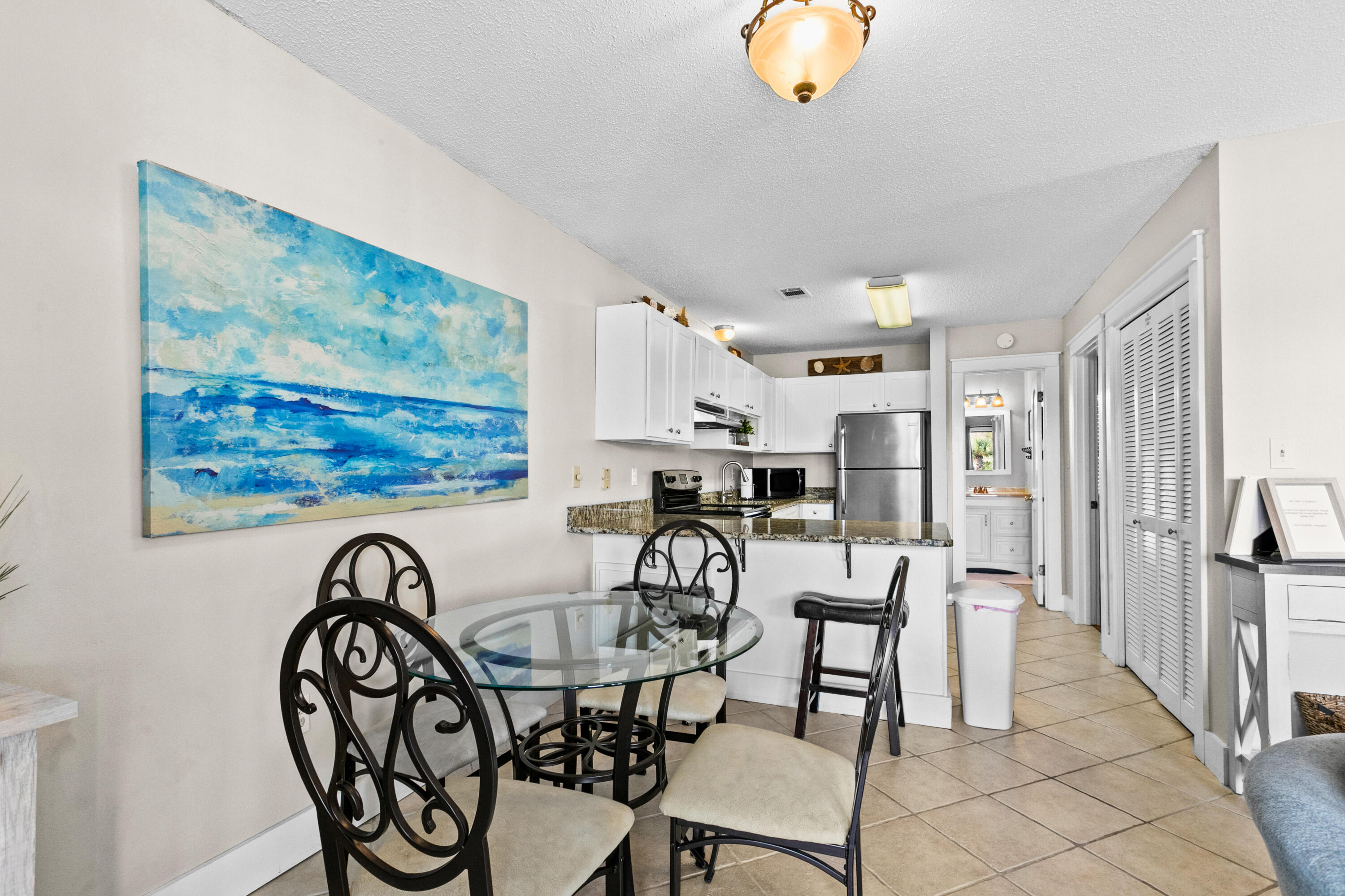 3799 East County Highway 30A, Unit F2 Santa Rosa Beach, FL 32459 - Photo 10 of 21 a view of a dining room with furniture wooden floor and a rug