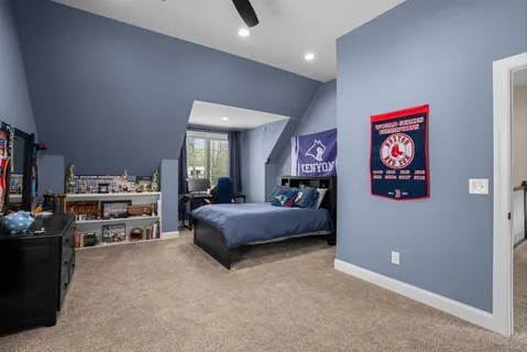 a bedroom with furniture and a book shelf