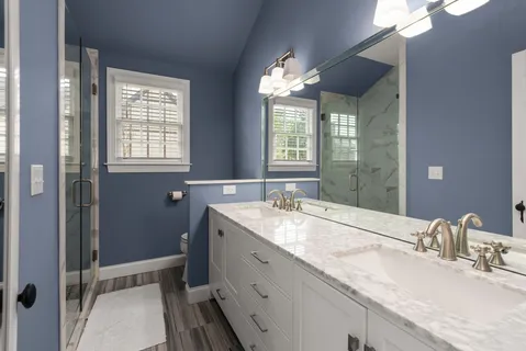 a bathroom with a granite countertop sink mirror and double