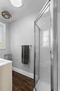 a bathroom with a shower a sink and a toilet