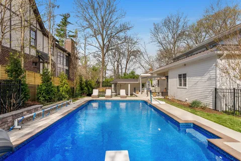 a view of a house with pool and sitting area