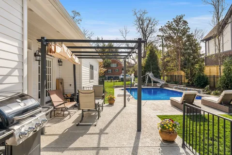 a view of a patio with couches table and chairs and potted plants