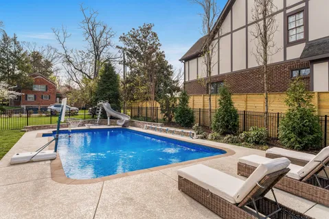 a view of a swimming pool with a lounge chairs