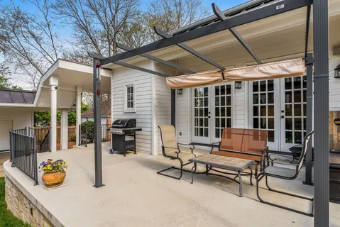 a building outdoor space with patio furniture and potted plants