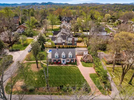 an aerial view of residential houses with outdoor space and city view