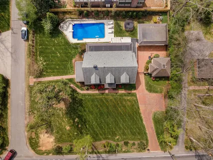 an aerial view of a house with a yard basket ball court and outdoor seating