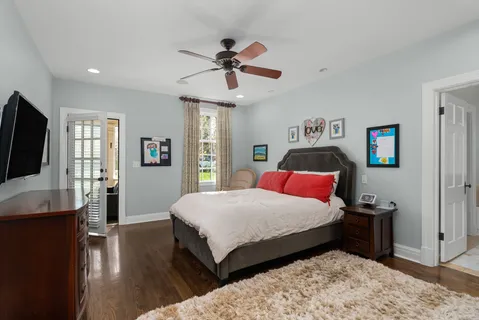 a bedroom with a bed and a flat screen tv