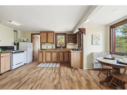 a kitchen with granite countertop a refrigerator stove top oven and sink