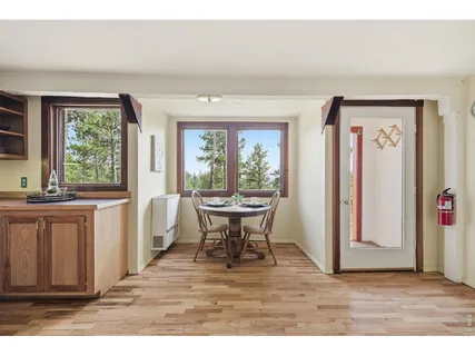 a view of a room with a window and wooden floor