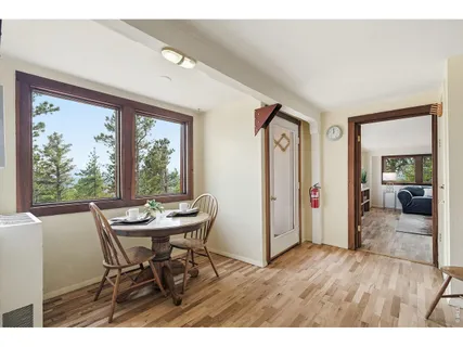 a dining room with furniture and wooden floor