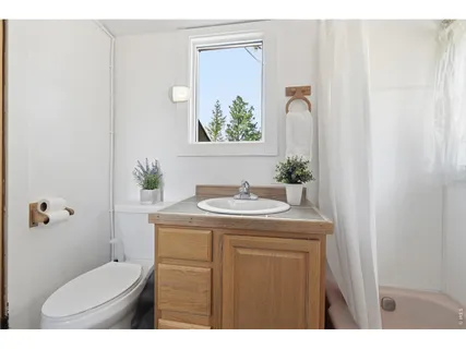 a bathroom with a granite countertop sink a toilet and a mirror