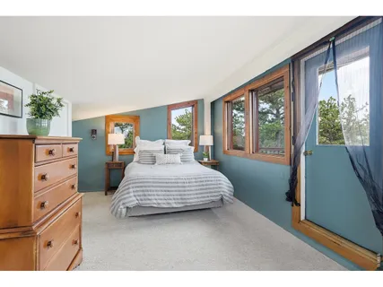 a bedroom with a large bed and a dresser