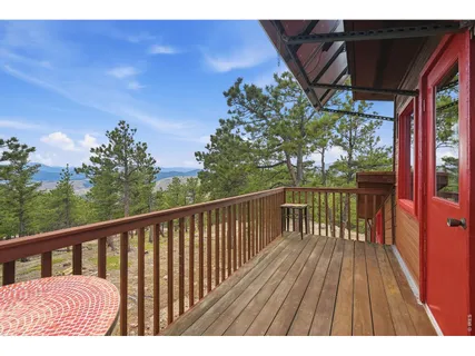 a view of balcony with wooden floor and fence