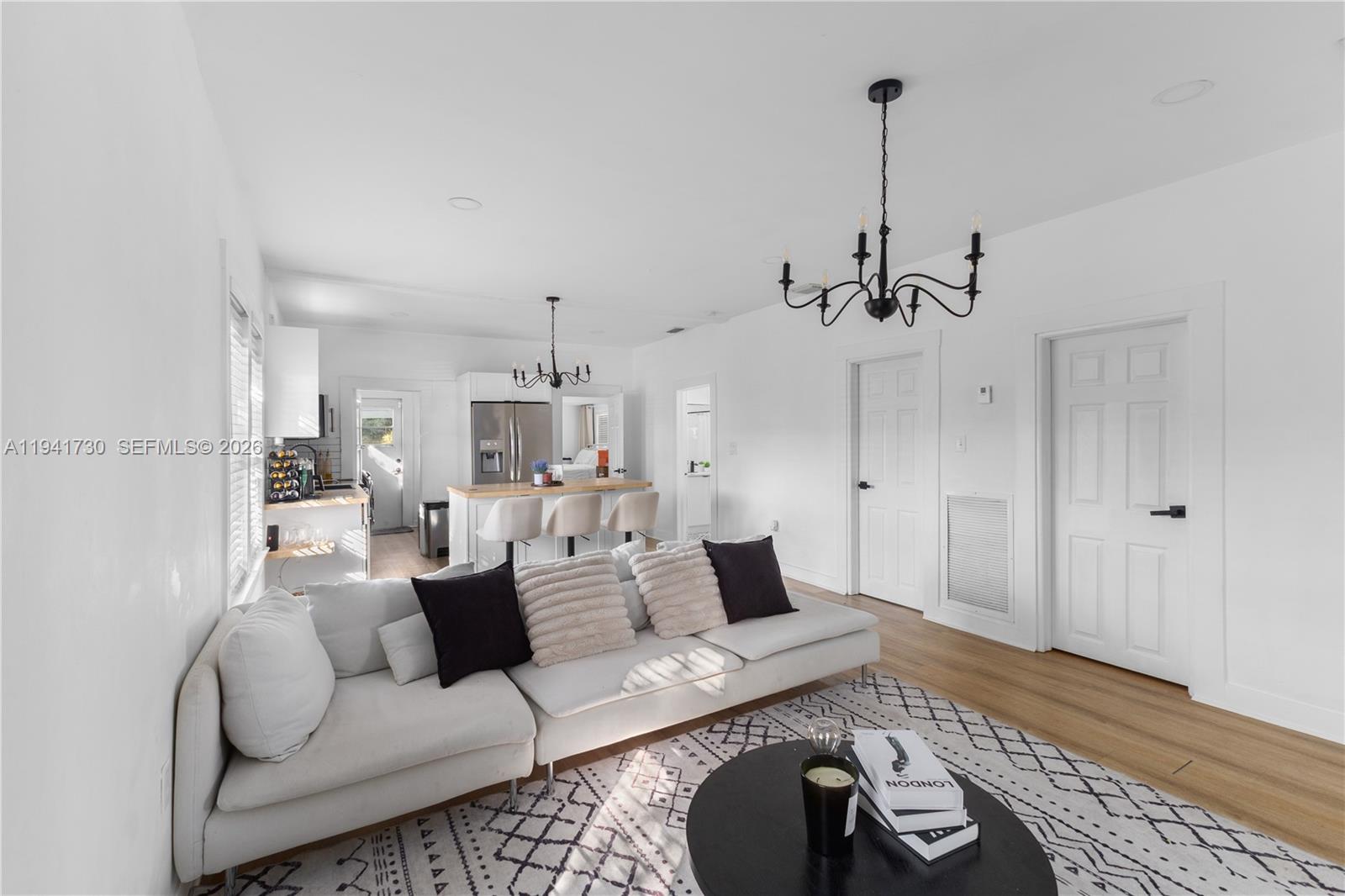 2811 Southwest 17th Street Miami, FL 33145 - Photo 17 of 36 a living room with furniture and a chandelier