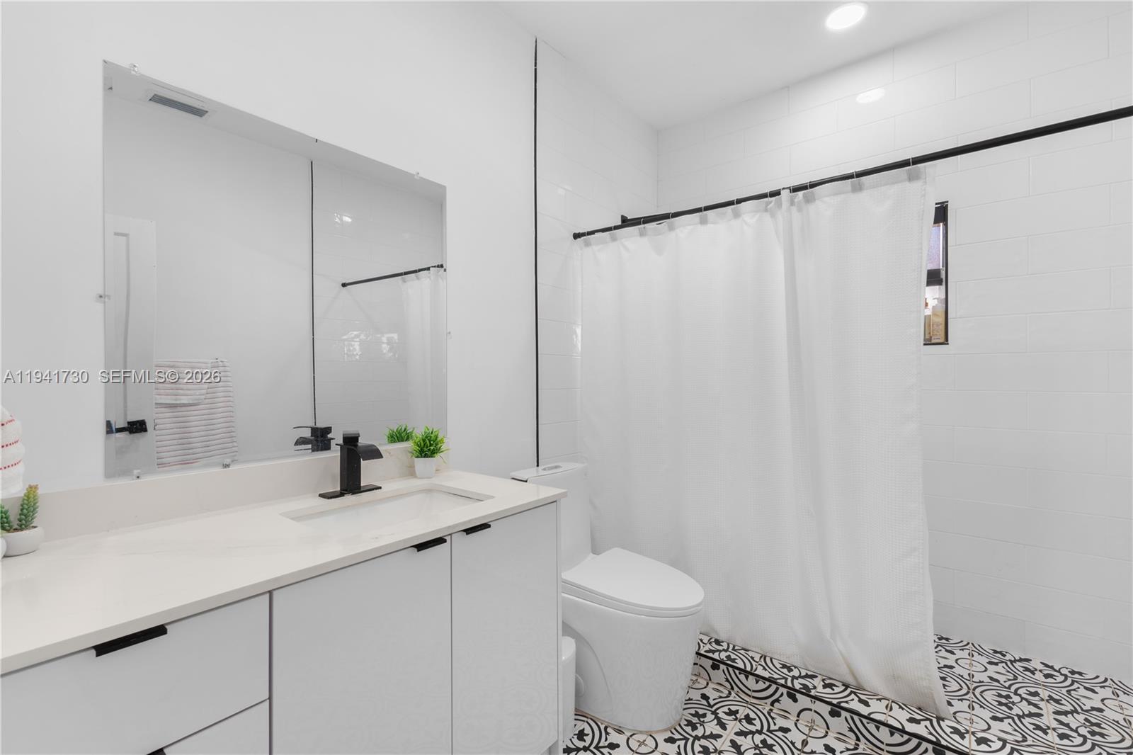 2811 Southwest 17th Street Miami, FL 33145 - Photo 18 of 36 a bathroom with a sink and a mirror