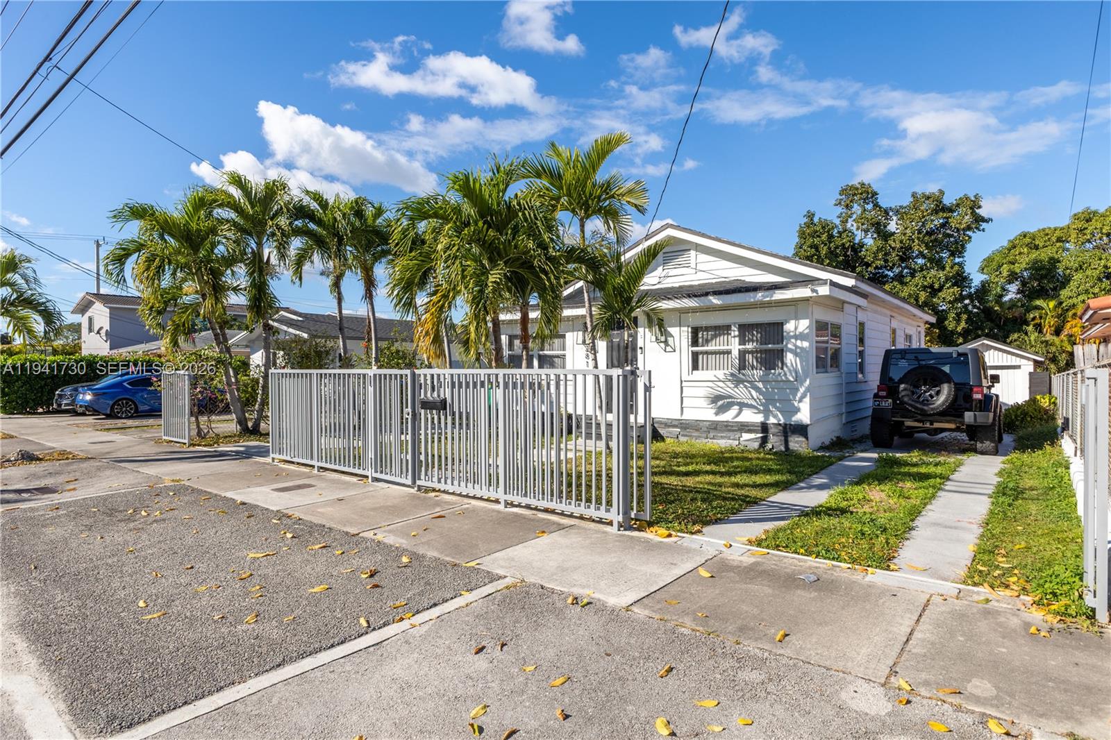 2811 Southwest 17th Street Miami, FL 33145 - Photo 2 of 36 a view of a house with a yard and potted plants
