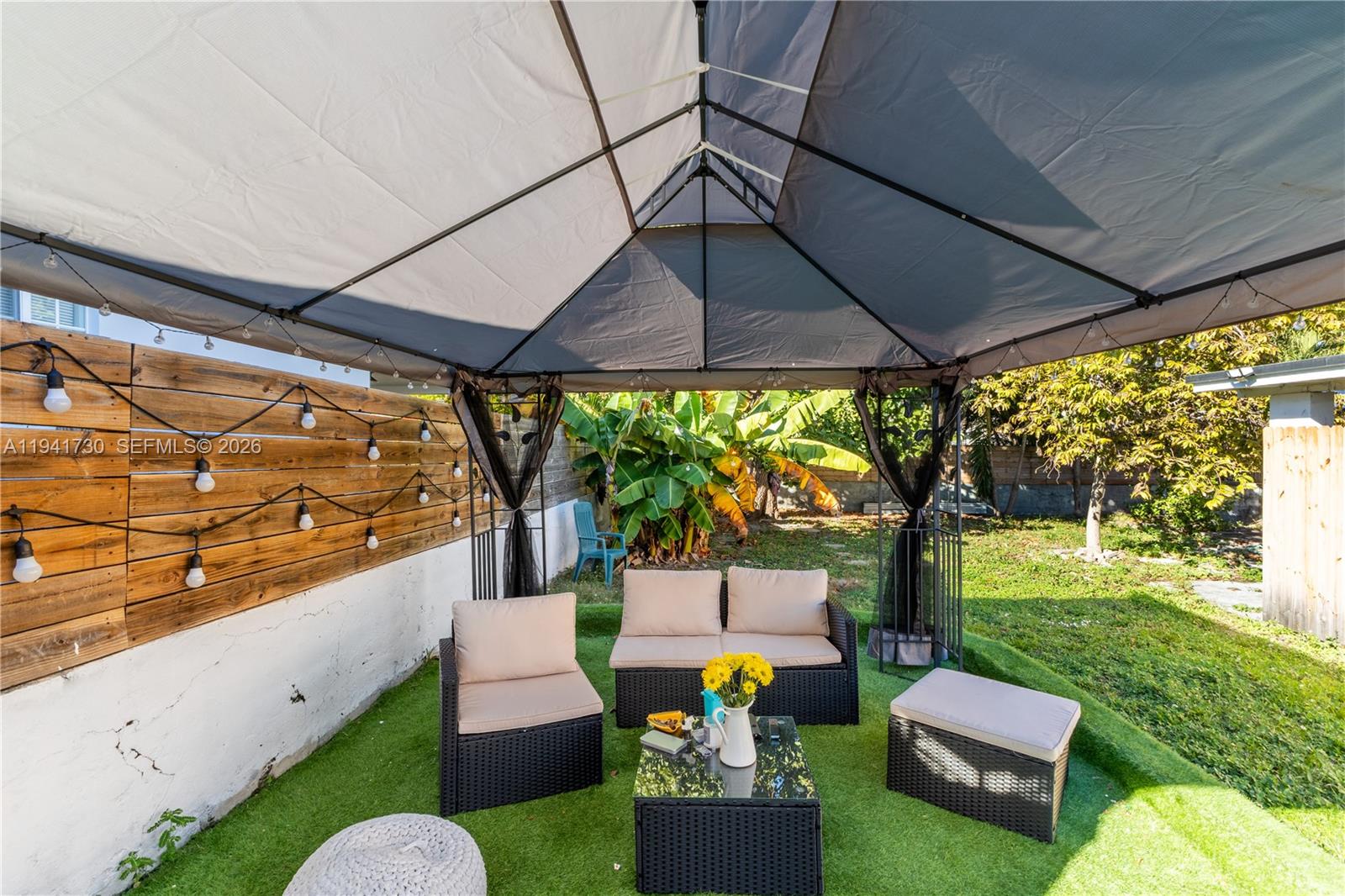 2811 Southwest 17th Street Miami, FL 33145 - Photo 25 of 36 a view of a patio with couches table and chairs under an umbrella