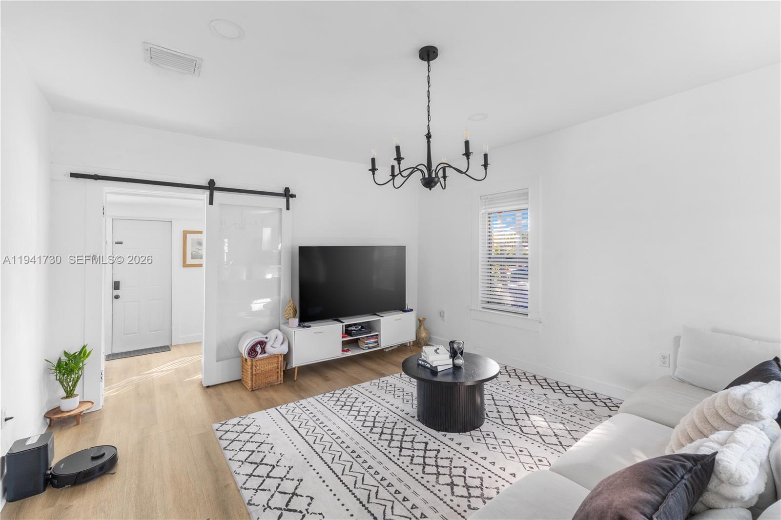 2811 Southwest 17th Street Miami, FL 33145 - Photo 10 of 36 a living room with furniture a flat screen tv and a window