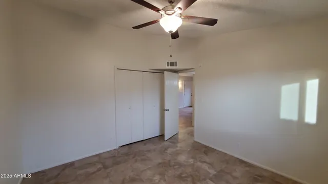 a view of a chandelier fan and closet in a room
