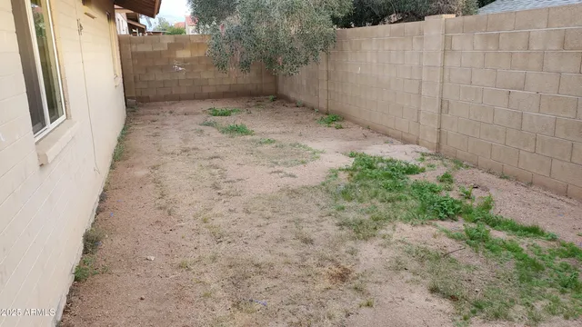 a view of a pathway with a wooden fence