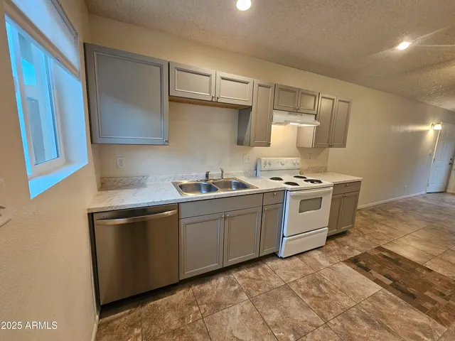 a kitchen with stainless steel appliances a sink and a stove